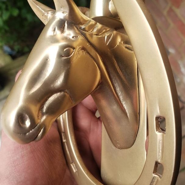 Aluminium gold horse head gracefully restored by vapour blasting